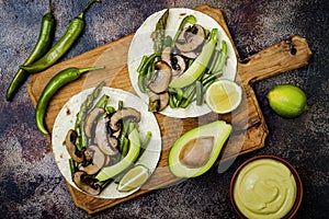 Grilled portobello, asparagus, bell peppers, green beans fajitas. Poblano mushroom tacos with jalapeno, cilantro, avocado crema photo