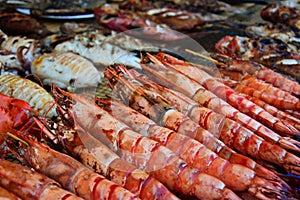 Grilled prawns and other seafood displayed in night market photo