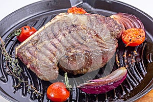 Grilled premium rib eye beef steak in the pan, cooking steak in the kitchen on a dark background, top view