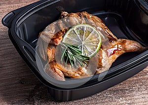 Grilled quail in a plastic container