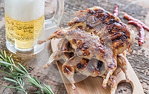 Grilled quails with glass of beer