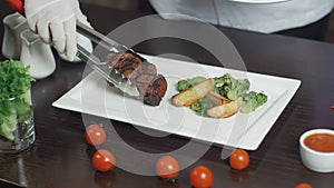 Grilled red beef pork meat barbecue steak fillet with broccoli and potato served on white rectangular plate