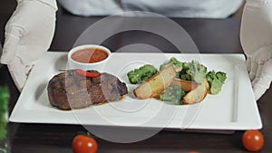 Grilled red beef pork meat barbecue steak fillet with broccoli and potato served on white rectangular plate