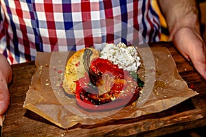 Grilled red bell pepper and feta cheese on a wooden board