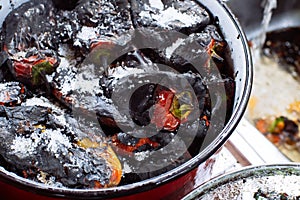 Grilled red bell peppers with salt, in a cooking pot