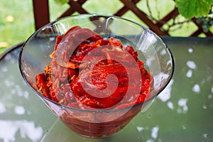 Grilled red bell peppers with salt, in a cooking pot