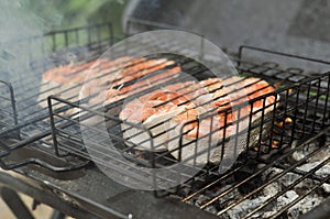 Grilled red fish steak salmon on the grill pan, closeup view