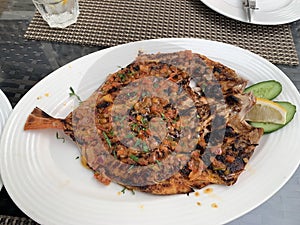 Grilled red snapper marinated with herbs and spices