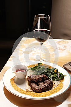 Grilled ribeye beef steak with red wine, herbs and spices on stone table