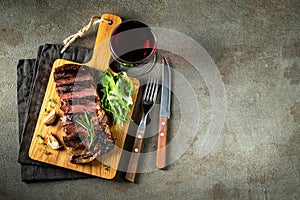 Grilled ribeye beef steak with red wine, herbs and spices. Top view with copy space for your text. Flat lay