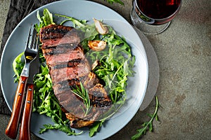 Grilled ribeye beef steak with red wine, herbs and spices. Top view. Flat lay