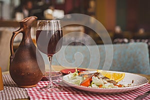 Grilled ribeye beef steak with red wine, herbs and spices on wooden table