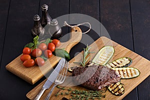 Grilled ribeye beef steak with vegetables and spices