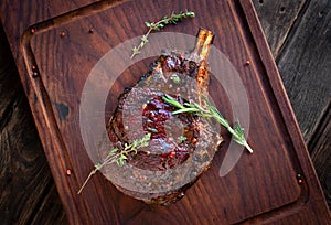 Grilled Ribeye Steak on bones on wooden board