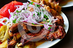 Grilled ribs with marinated onions and grilled vegetables.