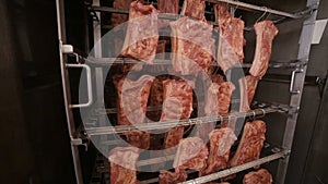 Grilled ribs, meat products at a smokehouse rack in a food factory.