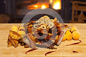 Grilled ribs topped with barbecue sauce and onion rings