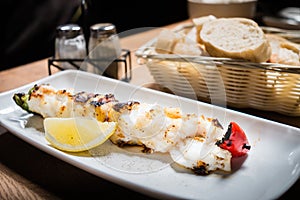 Grilled or roasted icelandic cod fish with lemon on white dish o