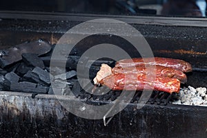Grilled roasted pork meat on charcoal, barbecue. Concept of cooking meat on coals, in restaurant on live fire, on the street