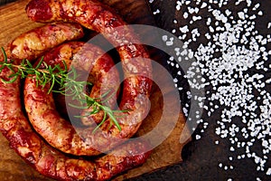 Grilled or Roasted spiral pork sausages with rosemary, salt and peper