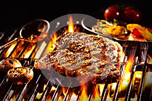 Grilled rump steak with mushrooms over flames photo