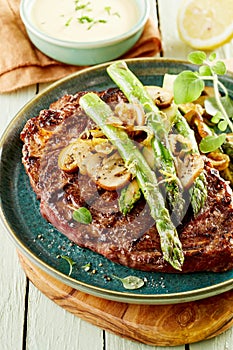 Grilled rump steak topped with green asparagus