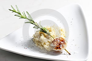 grilled Saint Jacques mollusc on rosemary needle with risotto