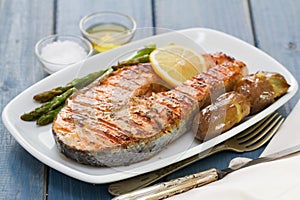 Grilled salmon asparagus and potato on white dish