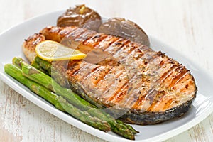 Grilled salmon asparagus and potato on white dish