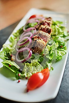 grilled salmon coated in sesame salad with bulgur and vegetables