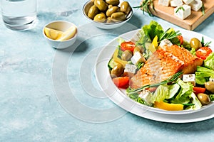 Grilled salmon fish fillet and greek salad