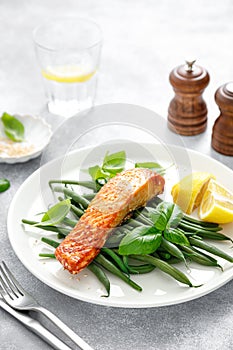 Grilled salmon fish fillet and green beans with lemon and basil