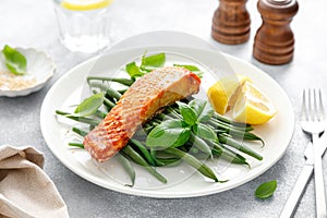 Grilled salmon fish fillet and green beans with lemon and basil