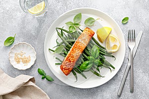 Grilled salmon fish fillet and green beans with lemon and basil