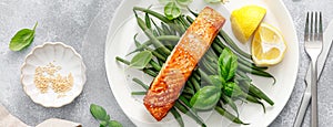 Grilled salmon fish fillet and green beans with lemon and basil. Banner