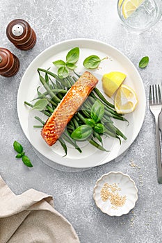 Grilled salmon fish fillet and green beans with lemon and basil