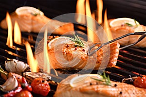 Grilled salmon fish on the flaming grill