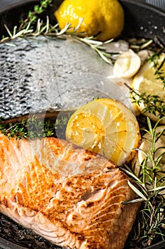 Grilled salmon fish with herbs, garlic and lemon. Healthy seafood