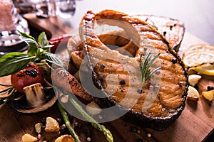 Grilled salmon fish with seasoning and various vegetables