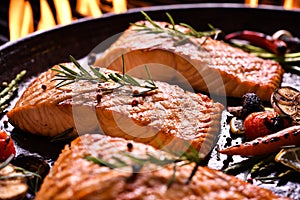 Grilled salmon fish with various vegetables on pan