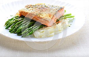 Grilled salmon garnished with asparagus and herbs and mashed potatoes