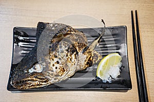 Grilled salmon head on the plate