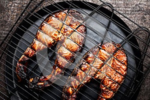 Grilled salmon on iron grill grate