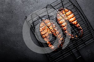 Grilled salmon on iron grill grate