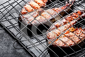 Grilled salmon on iron grill grate