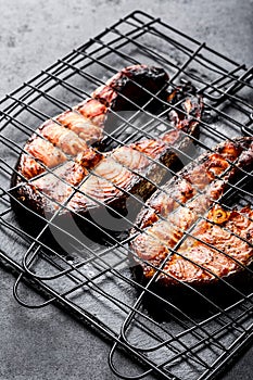 Grilled salmon on iron grill grate