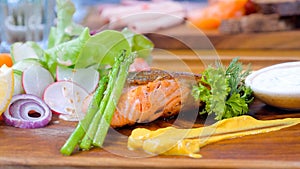 Grilled salmon with mixed vegetables on a plate, a perfect dish for a healthy meal