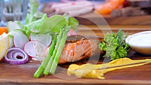 Grilled salmon with mixed vegetables on a plate, a perfect dish for a healthy meal