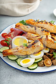 Grilled salmon nicoise salad with fresh vegetables and eggs