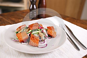 Grilled salmon with radish and spinach, served on white plate. View from above, top studio shot